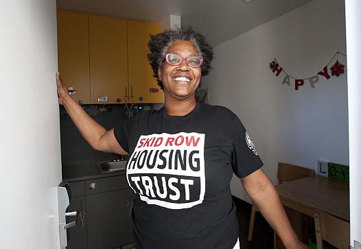 Evelyn Hilliard, formerly homeless on skid row, greets visitors at her studio in Star Apartments.